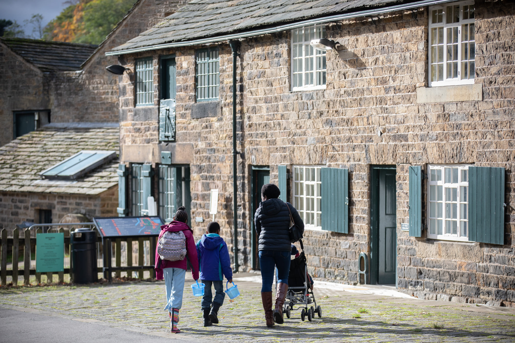 A family looking around the Abbeydale Industrial Hamlet.