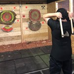 A person throwing two axes at targets in Battle Axe Sheffield.