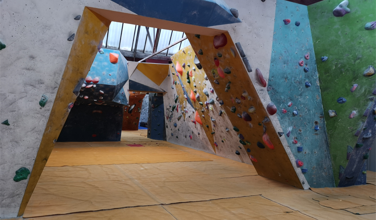 An archway covered in climbing holds at The Climbing Works.