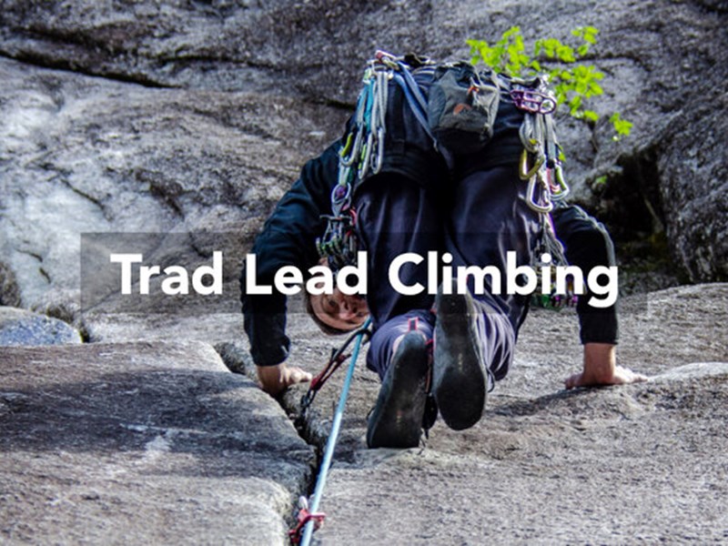 A person climbing a rock face, as seen from directly below. Over the image are the words 'Trad Lead Climbing'.
