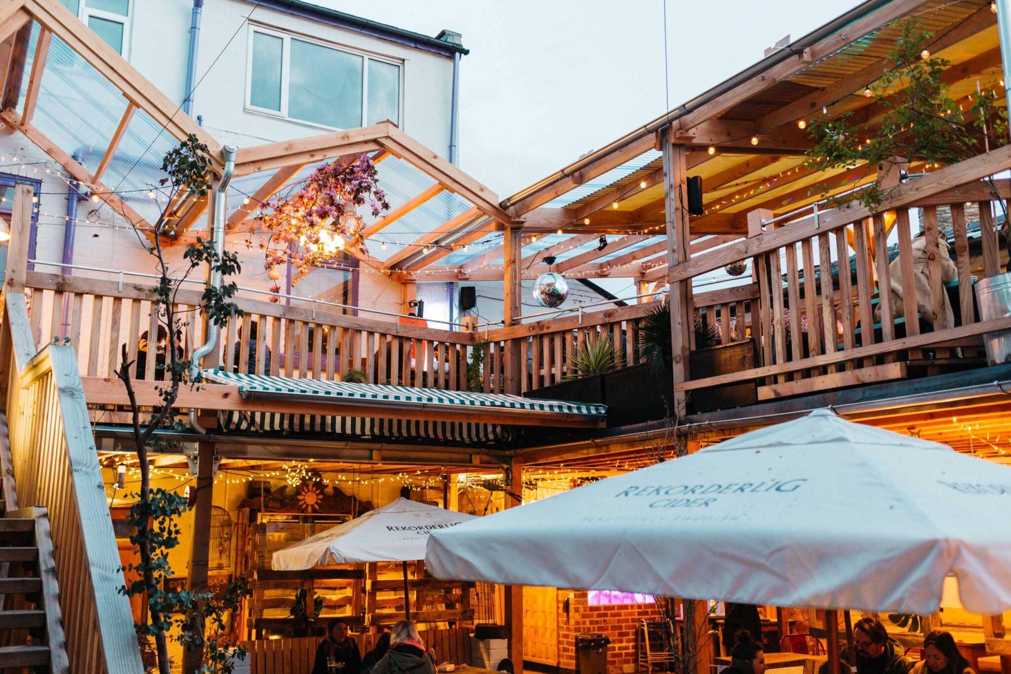 The courtyard at Hagglers Corner, filled with tables and chairs. You can also see the balcony that runs around the second floor.
