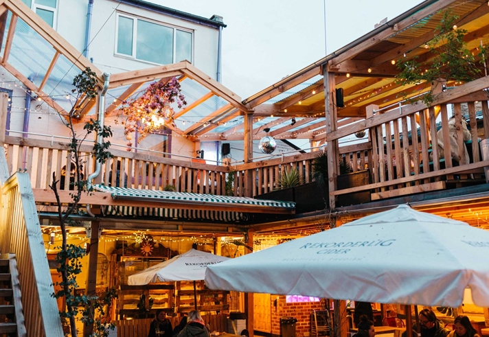 The courtyard at Hagglers Corner, filled with tables and chairs. You can also see the balcony that runs around the second floor.