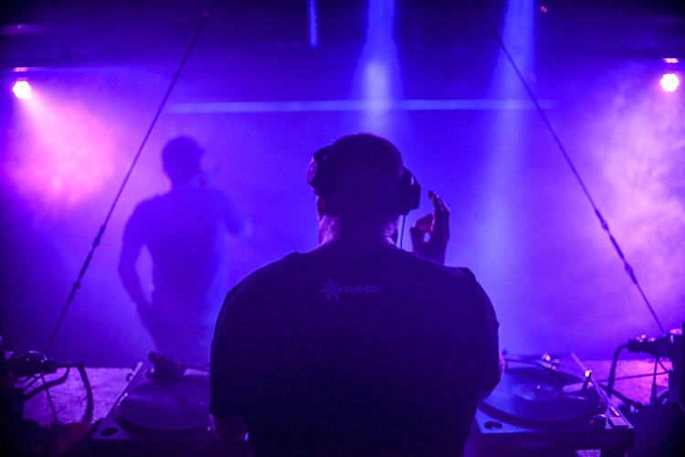 A DJ playing in a nightclub.