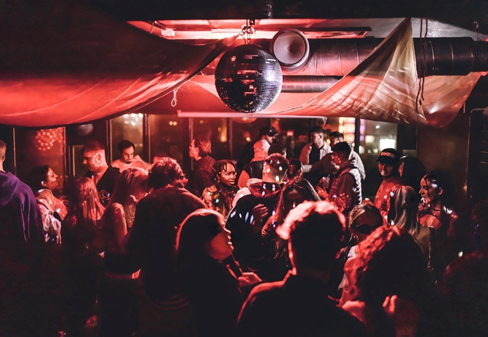 Disco ball above people dancing at Panke Social