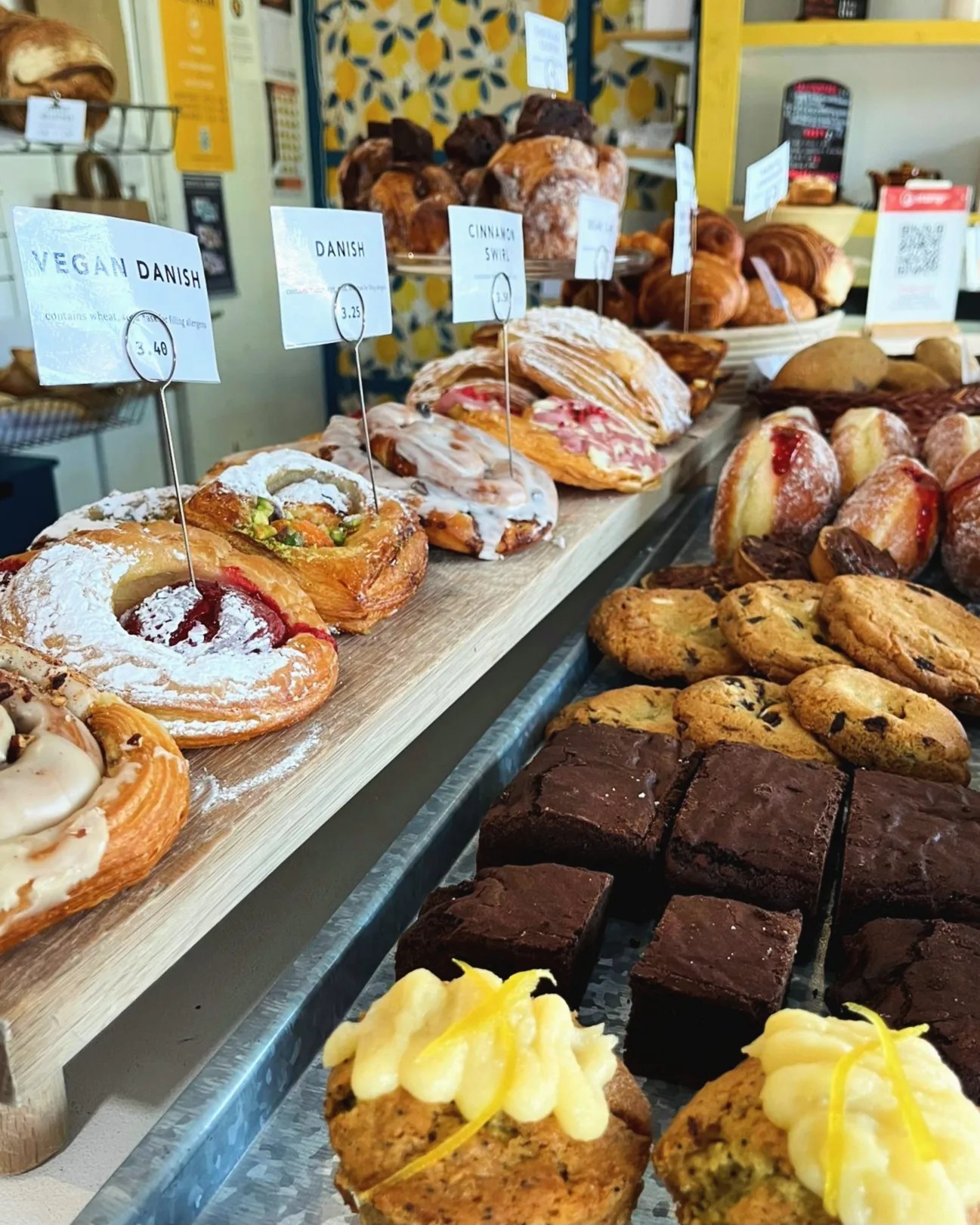 A counter full of cakes and pastries.