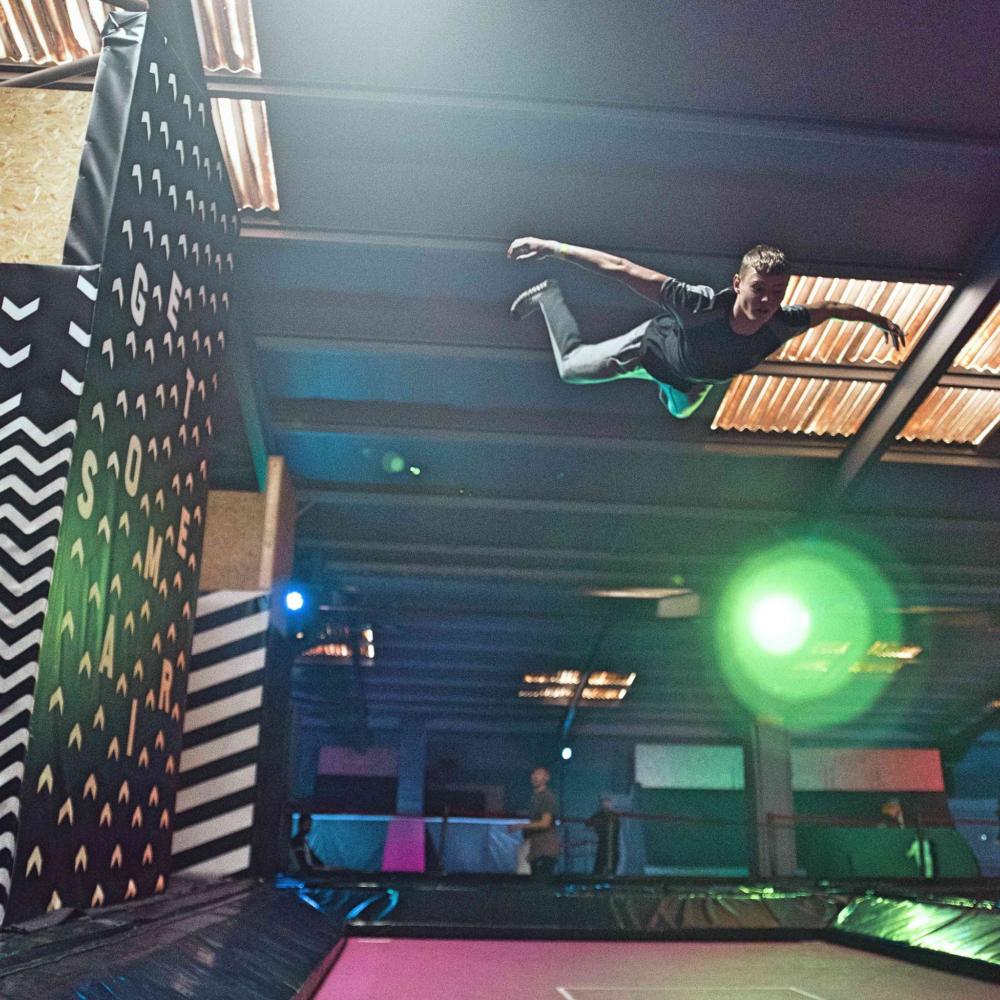 A man having fun, jumping on a trampoline at Jump Inc.