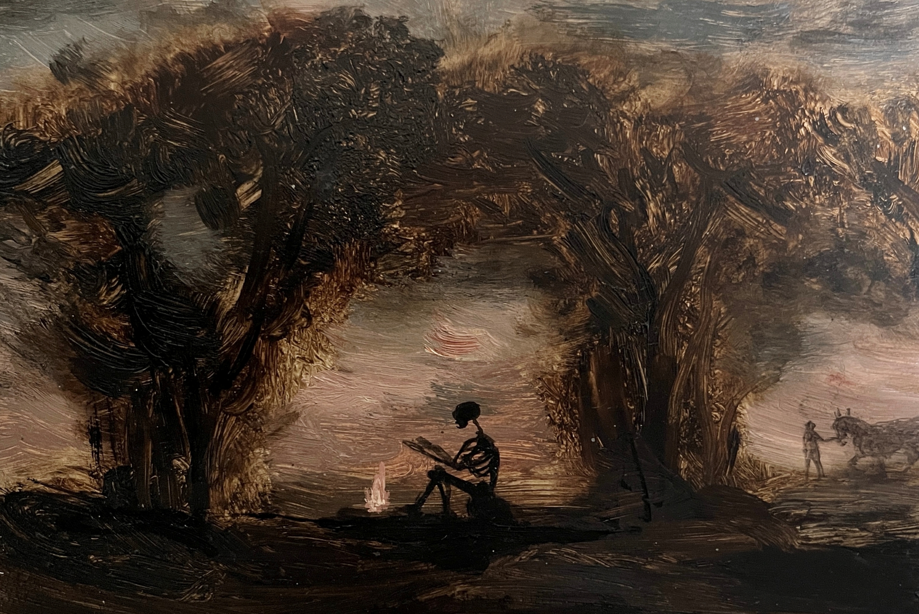 A painting of a skeleton sitting under trees by Lisa Ivory titled 'Night Trip'.