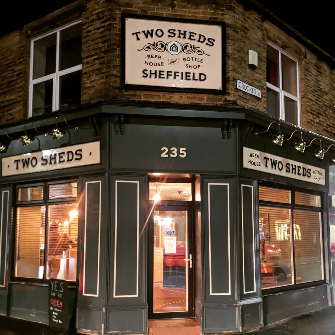 The exterior of the Two Sheds at night.