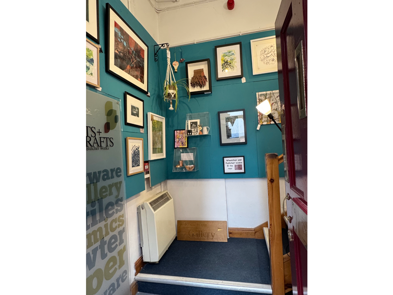 Walls covered in framed pictures at All Good Stuff.