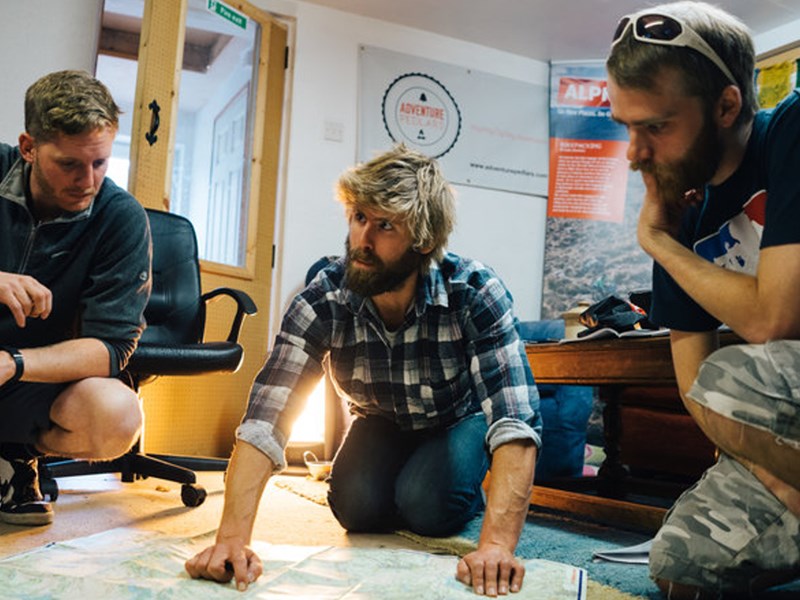 People gathered round looking at a map.
