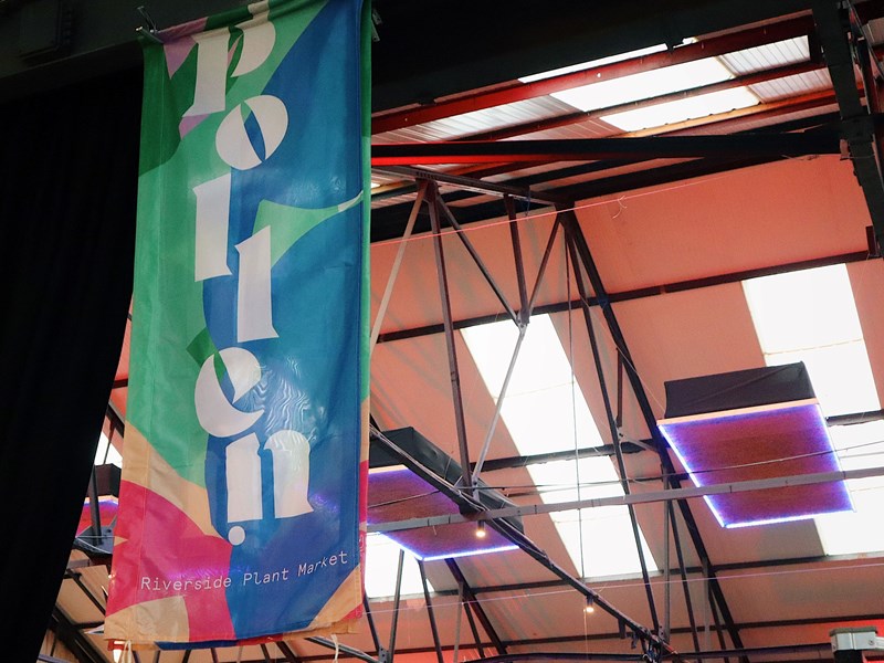 A Pollen Market banner hanging from the roof in Peddler Warehouse.