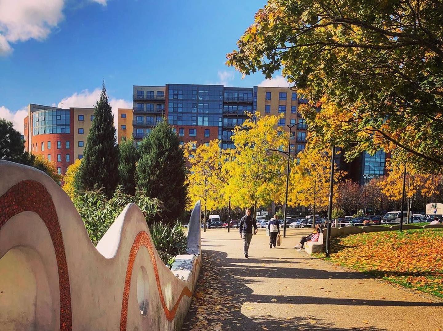 A path around Sheffield's Devonshire Green in the city centre showing the autumnal colours of the trees
