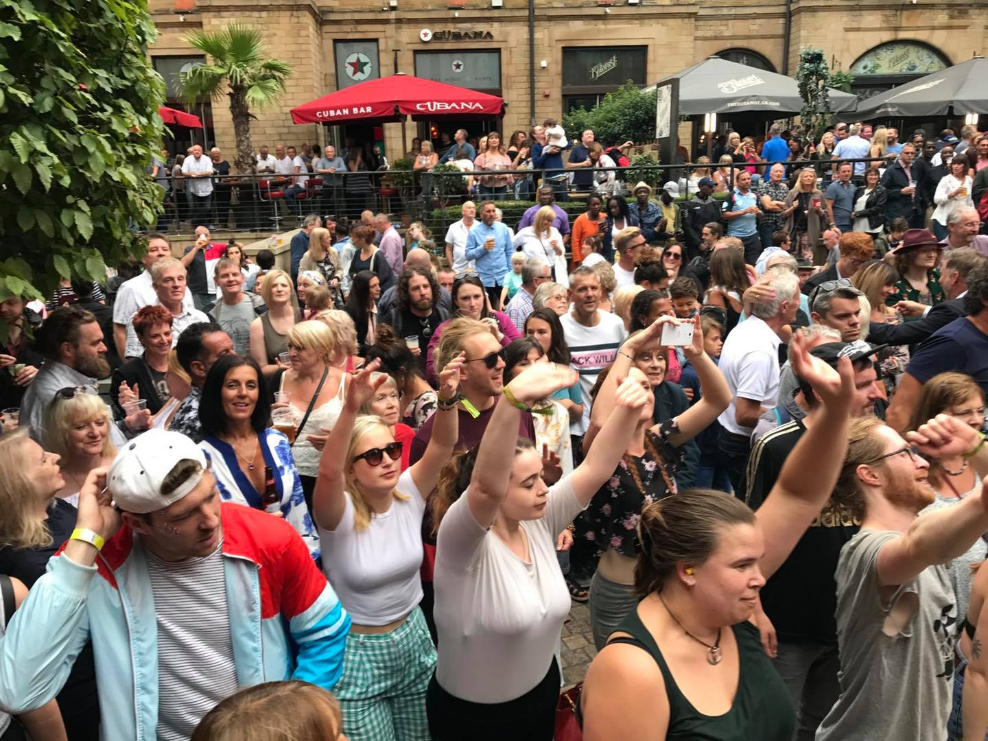 A crowd of people enjoying live music at Leopold Square.