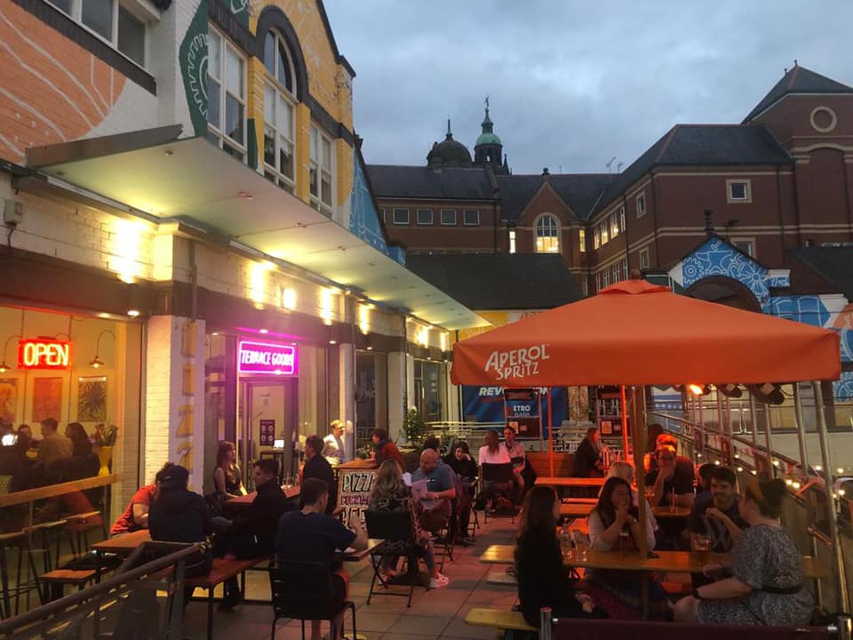 People dining outside at Terrace Goods, in the evening.