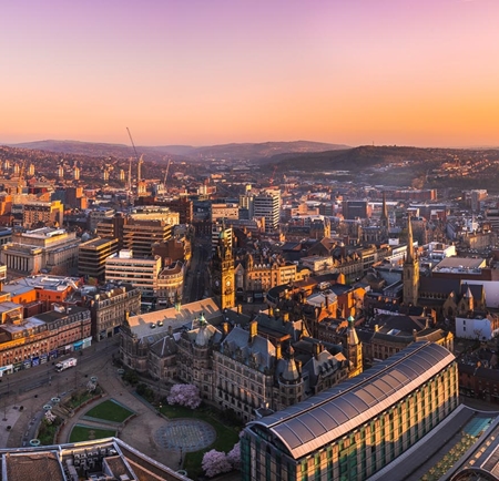 A panorama shot of the Sheffield skyline at sunrise.