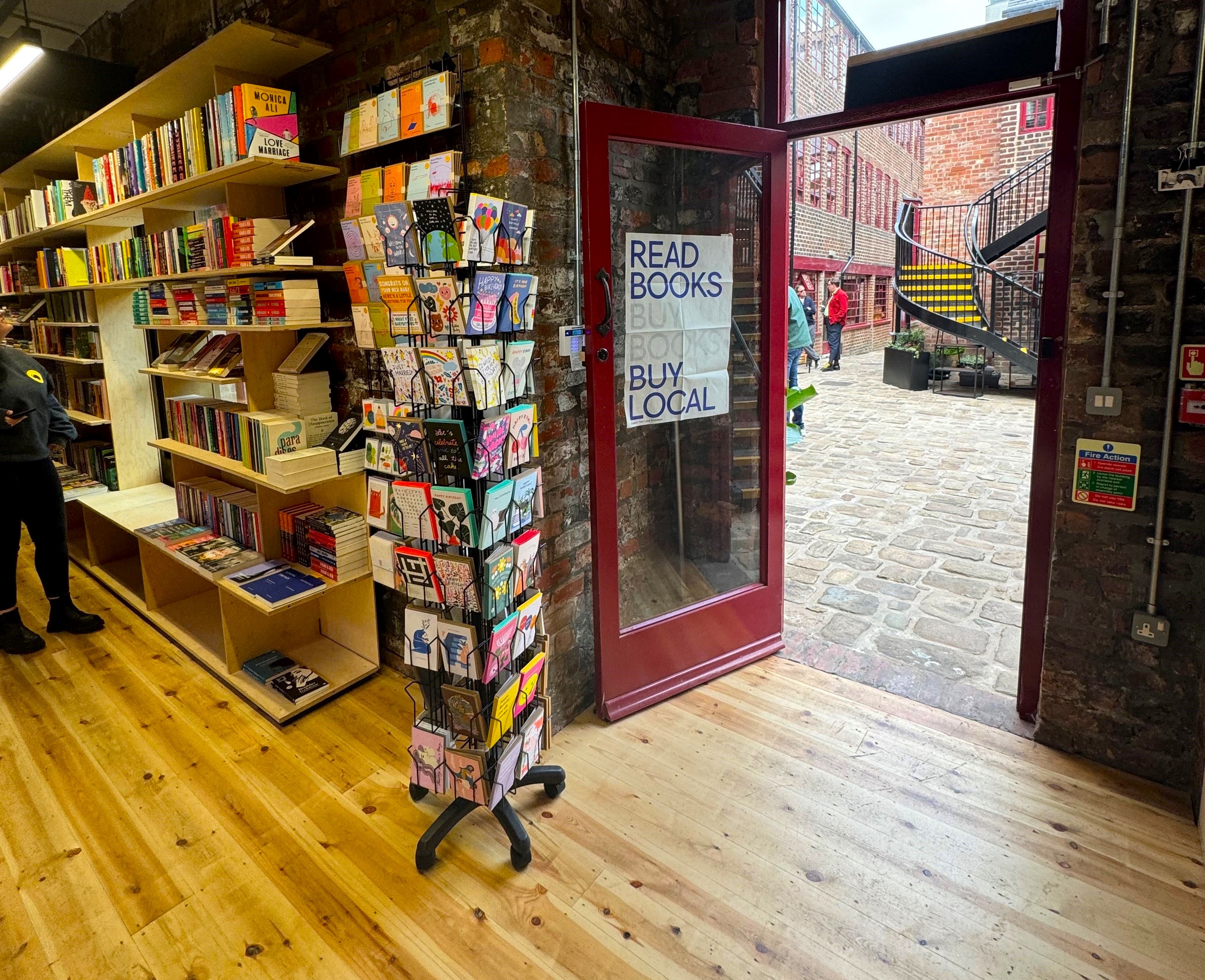 The door to La Biblioteka book shop opening out into Leah'd Yard 
