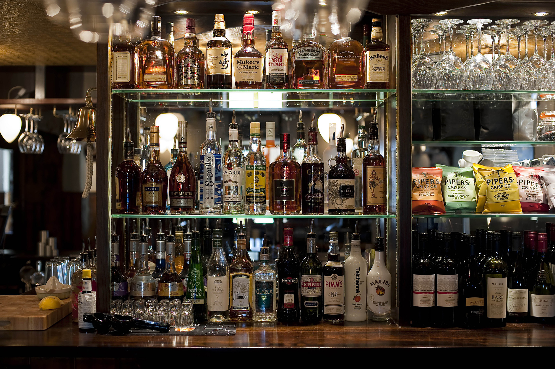 Shelves of spirits and bar snacks behind the bar at The British Oak.