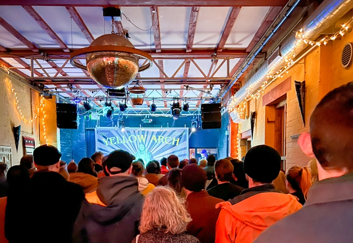 A crowd watches a band performing at Yellow Arch.