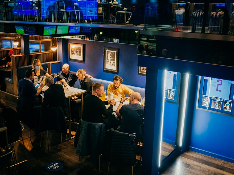 People eating at tables at The Wildcard Bar & Grill.
