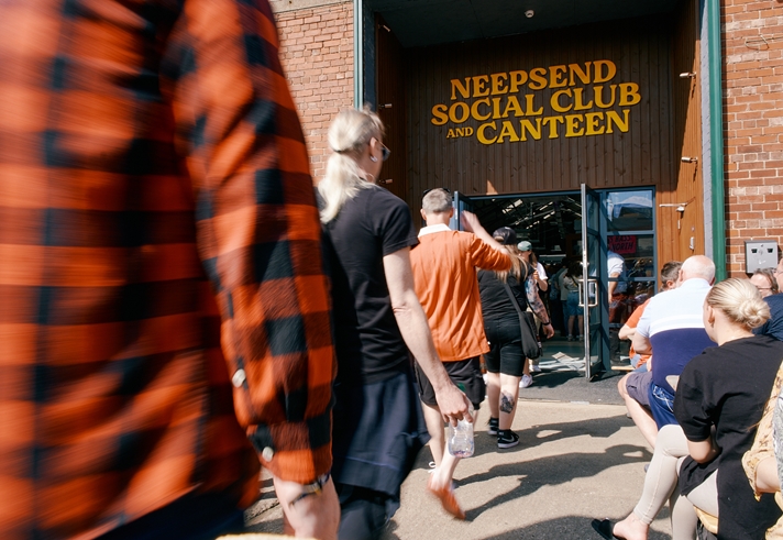 People walking into Neepsend Social Club, with distinct signage above the doorway