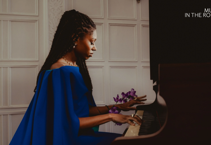 Isata Kanneh-Mason sitting at a piano, playing.