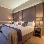 A Deluxe Hotel Room With Twin Beds.