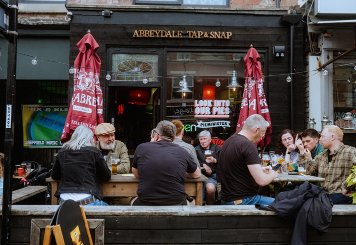 Groups of people sat drinking outside The Abbeydale Tap