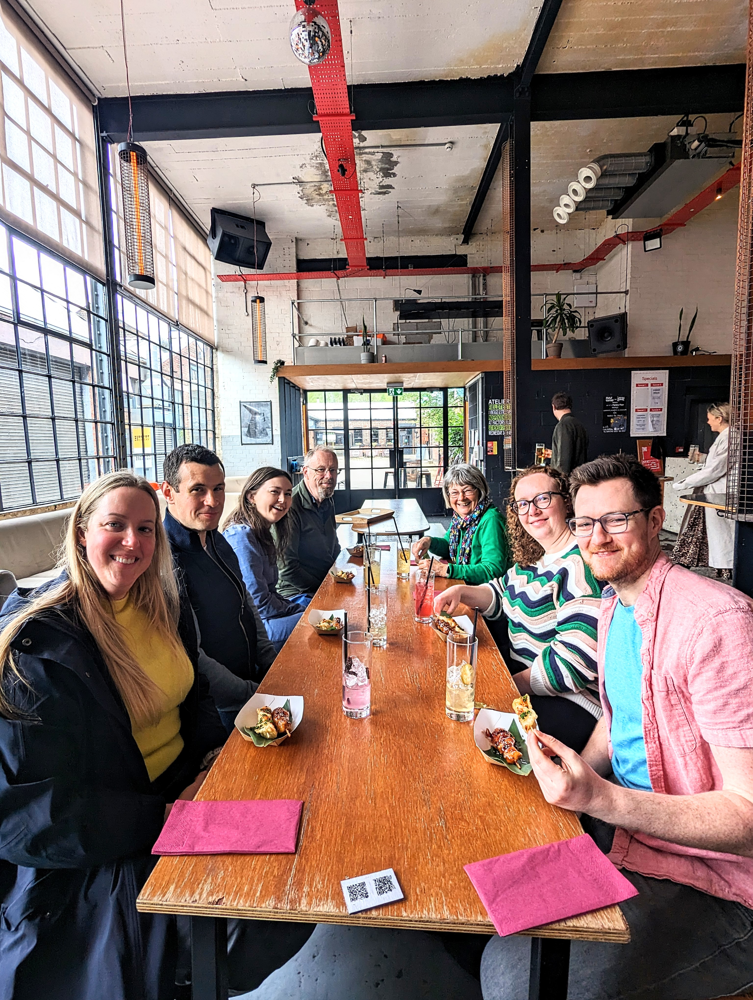 A group sat round a table on the Sheffield And Kelham Island Food Tour.