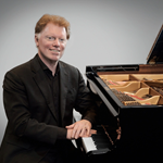 Tim Horton sat at a grand piano.