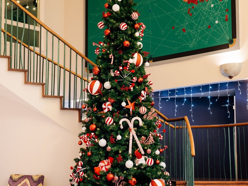 A dressed Christmas tree in the lobby of Mercure Sheffield Kenwood Hall Hotel & Spa.